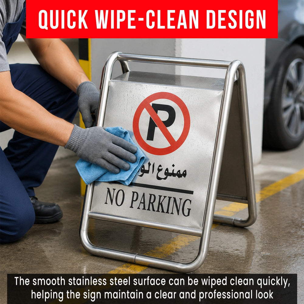 A stainless steel A-frame with a 'No Parking' graphic, shown outdoors while a person in gloves wipes the sign surface with a blue cloth. 