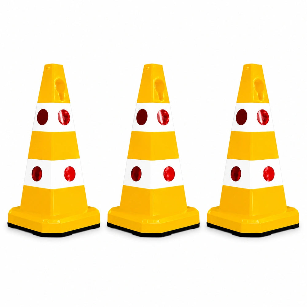 Three yellow and white plastic traffic safety cones